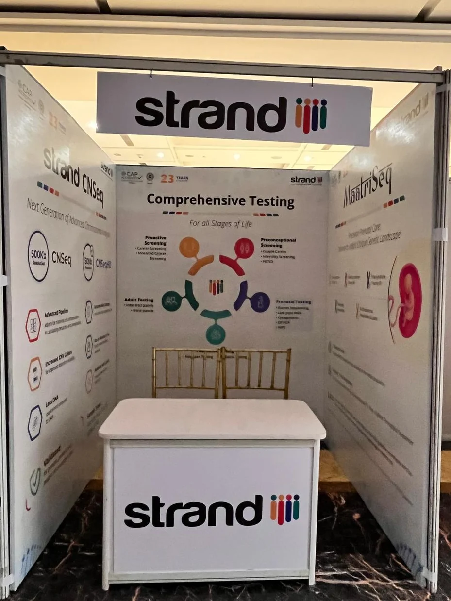 Strand Life Sciences exhibition stall fabricated by Ekraft India with branded back-wall graphics and counter