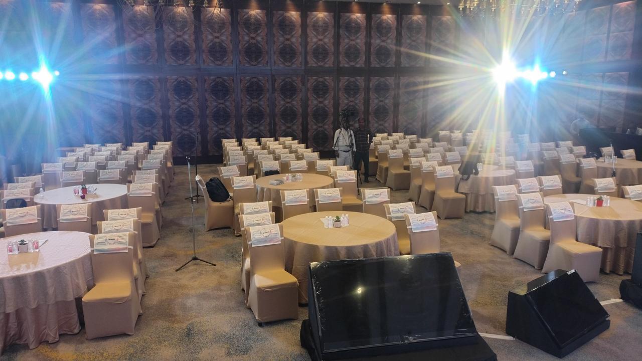 Strand Life Sciences conference and event setup with round tables, seating and stage lighting