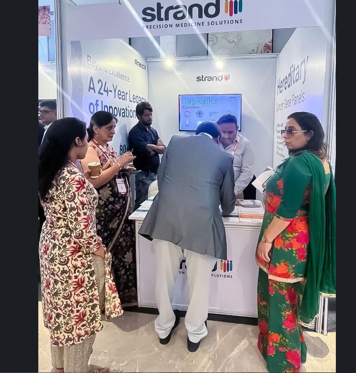Visitors engaging at the Strand Life Sciences exhibition stall fabricated by Ekraft India